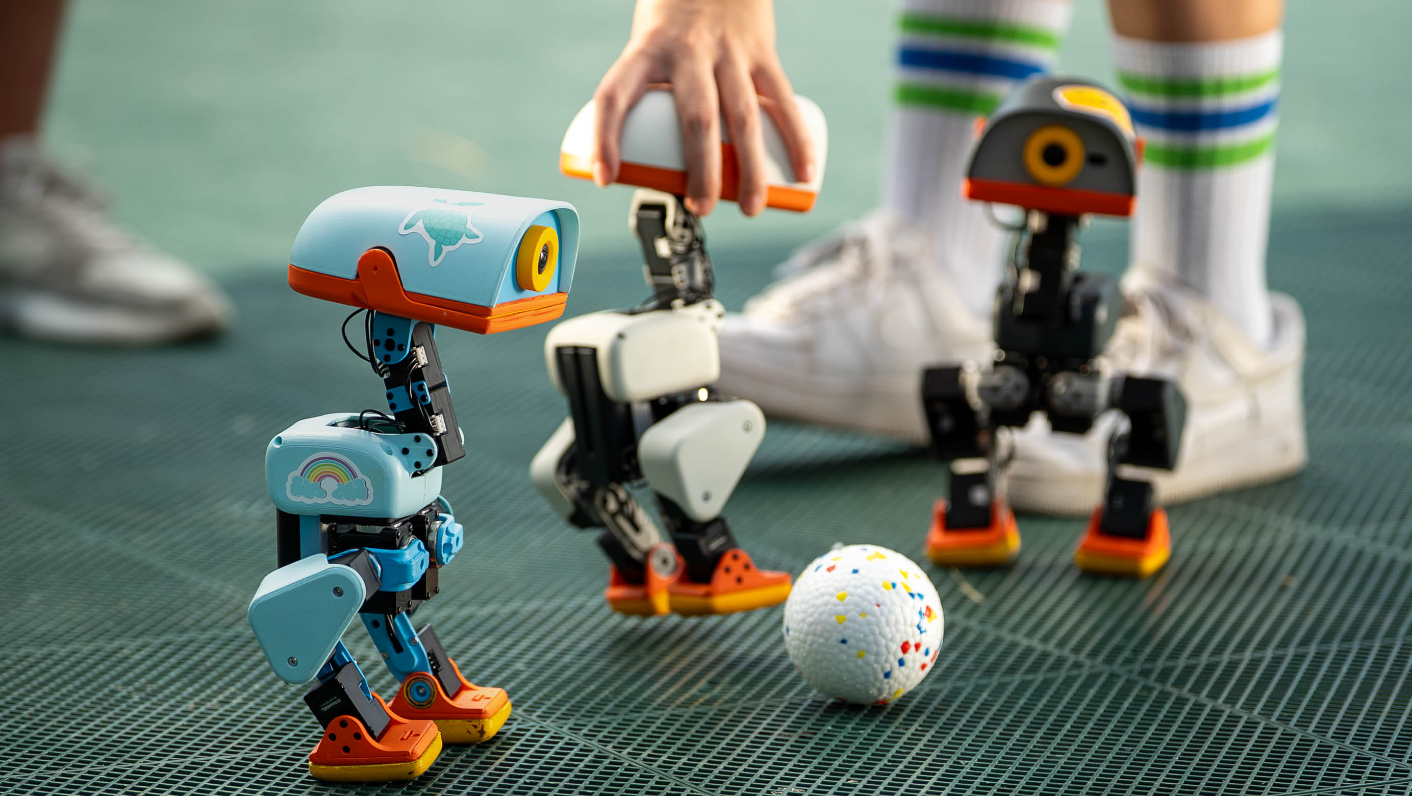 Microduck moving in a real-world scene from official Pollen Robotics press material