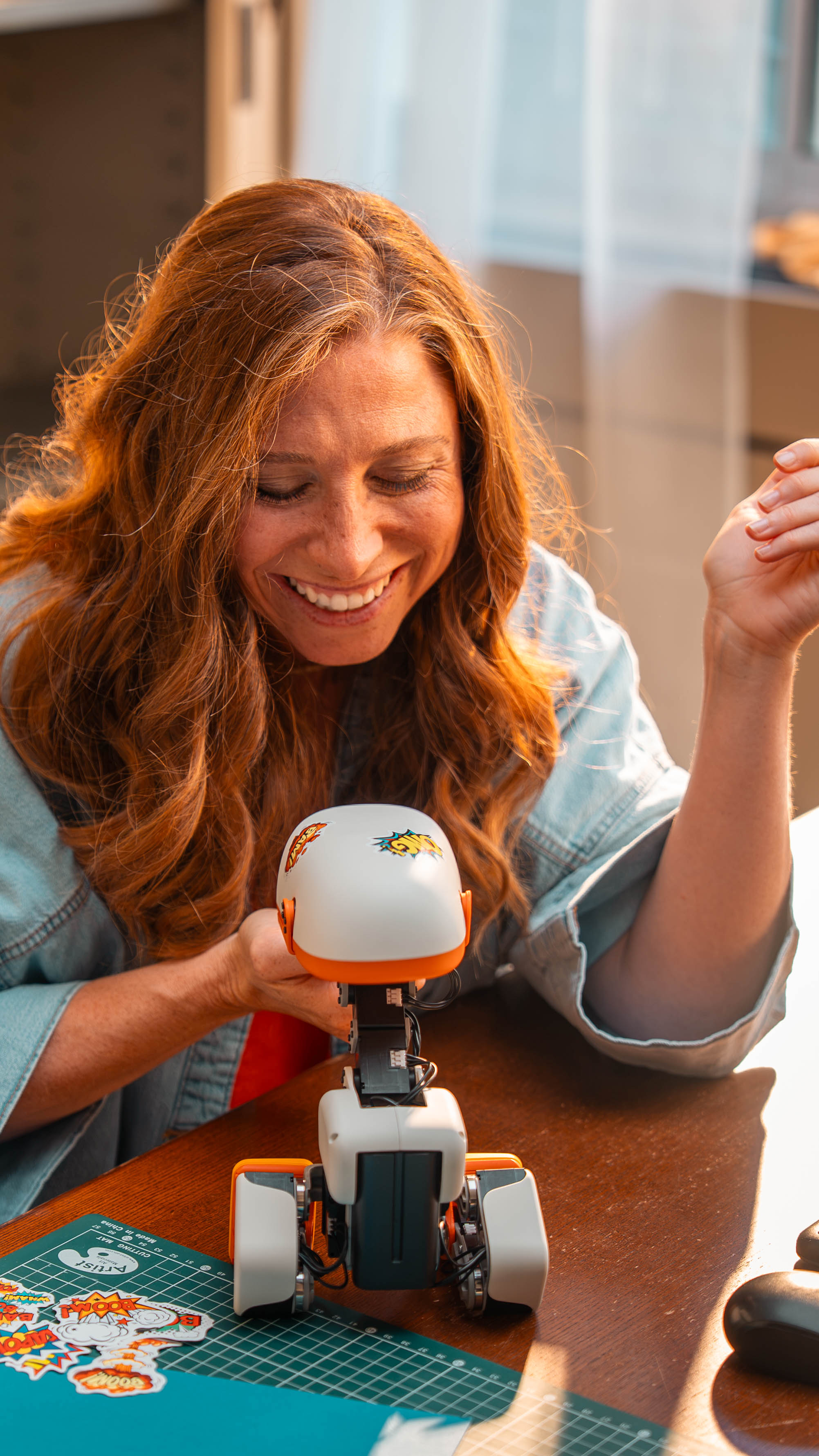 A user interacting with Microduck from official Pollen Robotics press material