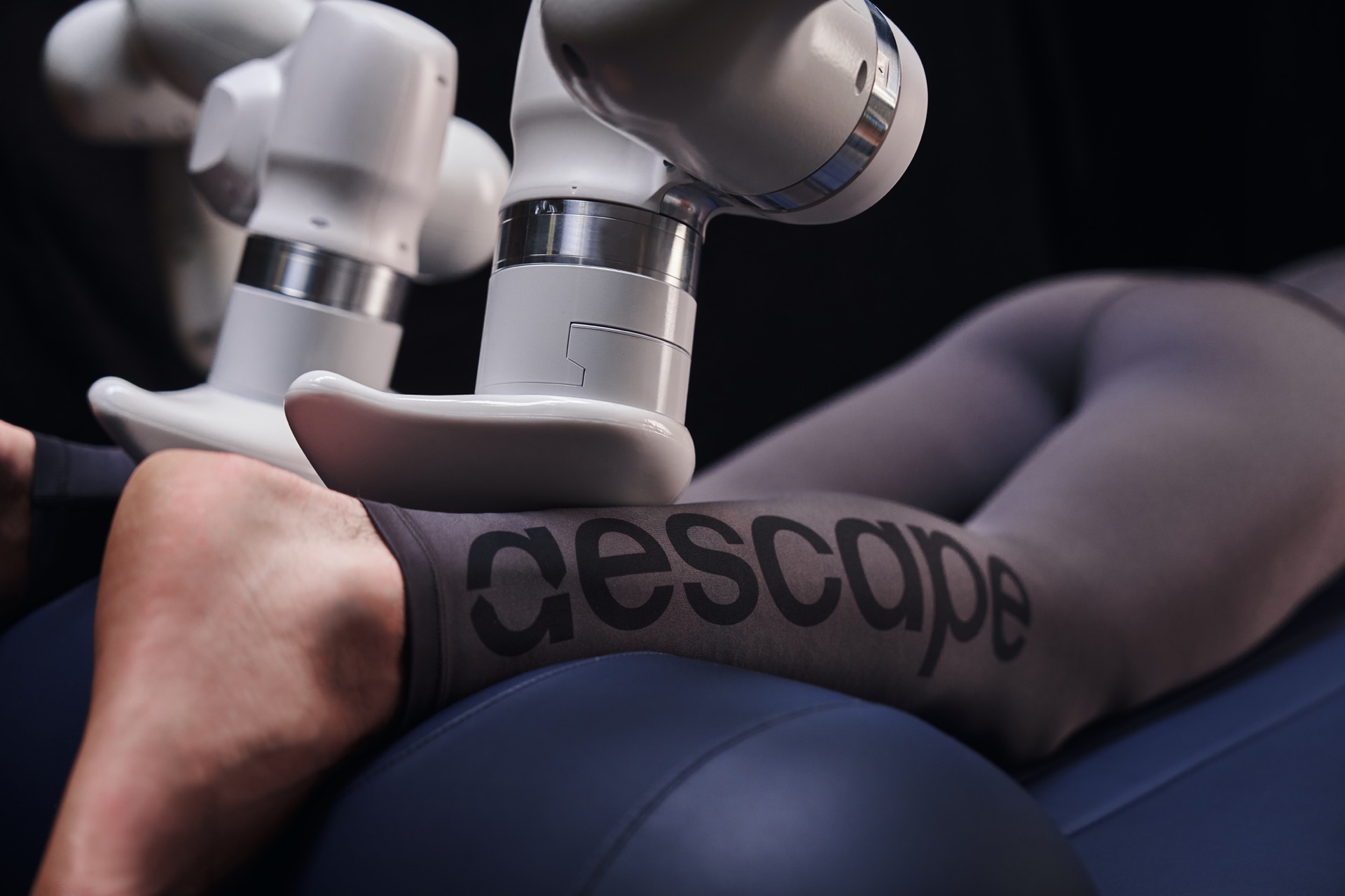 An Aescape robotic arm works on a customer’s calf.